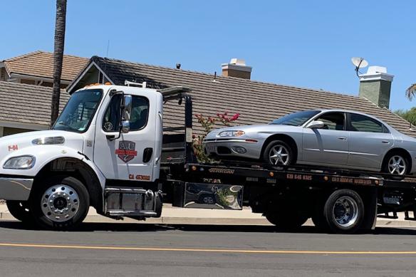 Tow truck hauling away a car